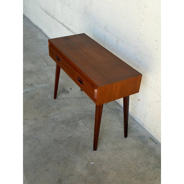 Beautiful vintage Scandinavian Modern console table crafted in warm teak by Glas & Trä, Sweden. This elegant piece...