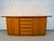 A beautifully crafted mid-century modern teak credenza by Skovby, exemplifying the clean lines and functional elegance of...