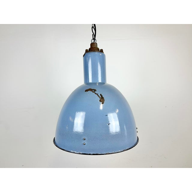 Vintage Industrial light in Bauhaus style made in former Czechoslovakia during the 1950s.It features a blue ( grey )...