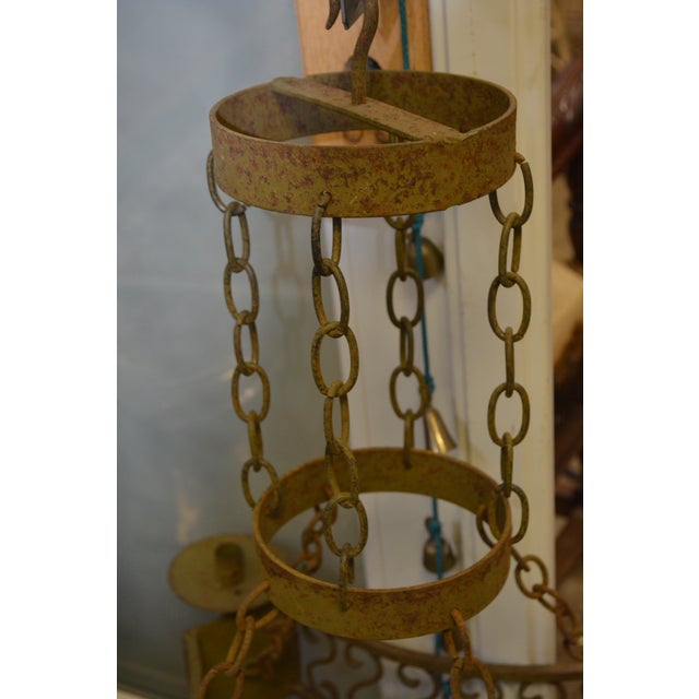 This is an awesome, cast iron/metal, candle chandelier. It is heavy & looks vintage. No name/maker. Simple iron hook/bar...