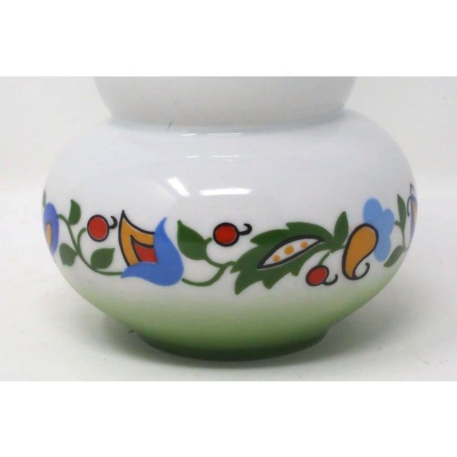A vintage, 1950's porcelain vase by Lubiana Poland, with a colorful floral band design and a green/white ombre design....