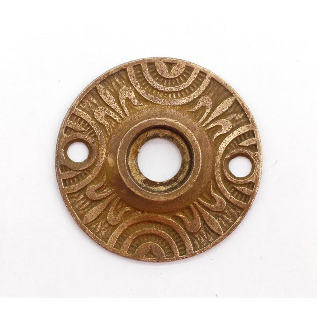 Ornate bronze door rosettes with two different patinas. Priced as a pair. The manufacturer and exact date of creation are...