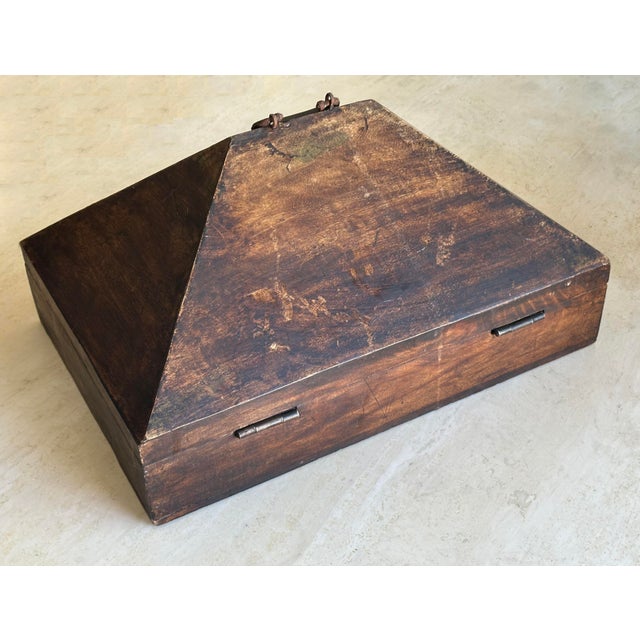 This evocative antique Indian dowry chest features a classic slanted lid, rich aged wood, and original iron handle and...