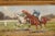 A pair of American horizontal oil on canvas paintings from the late 19th century, depicting horse races and set inside...