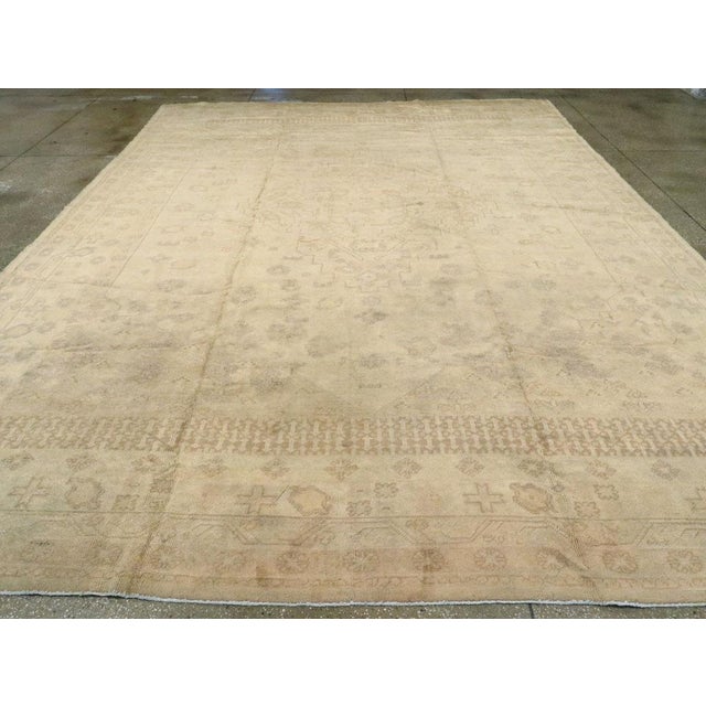 An antique Turkish Oushak room size carpet. An exceptionally pale western Anatolian workshop Oushak with a pearl grey...