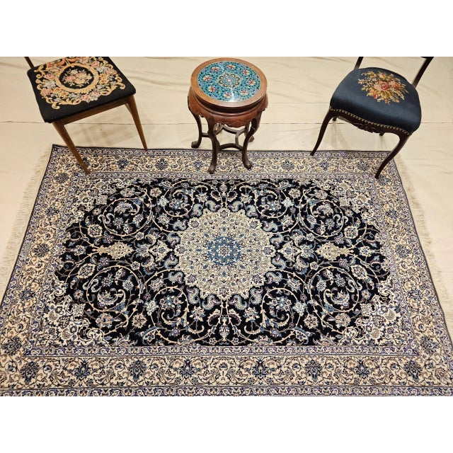 This exceptionally fine handwoven Persian Nain rug, signed by the renowned Habibian workshop, was crafted in the 4th...