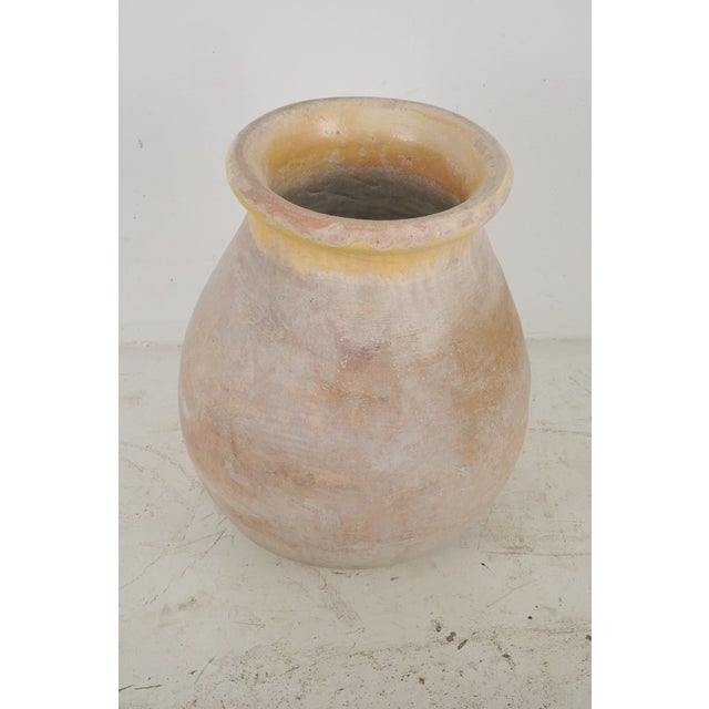 19th century olive jar made of blond terra cotta clay with a pale ochre glaze. It was made in Biot, Provence, France,...