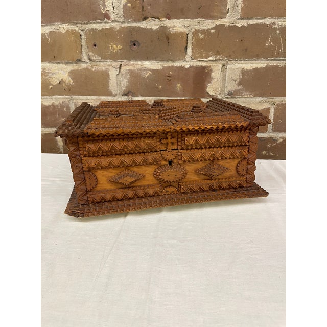 A finely crafted example of American folk art, this early-20th-century tramp art box showcases exceptional chip-carving...