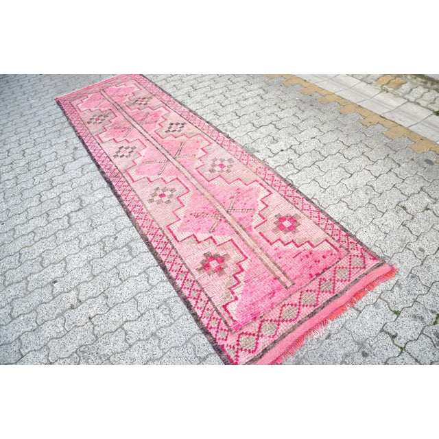 This is a vintage Turkish Oushak rug from the 1960s. The piece was hand-knotted.