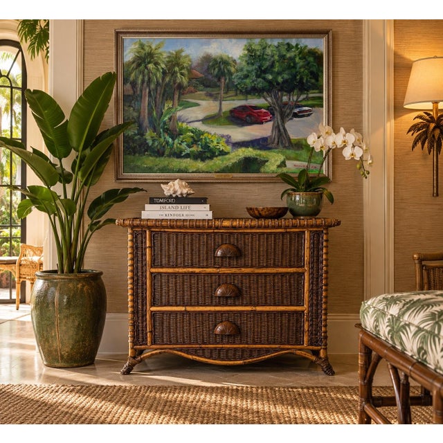 Beautiful vintage coastal nightstand crafted from natural bamboo and richly woven wicker. Features three spacious drawers...