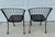 A vintage 1950s wrought iron garden chairs set of two by Woodard. 'Pinecrest' was one of their most charming designs in...