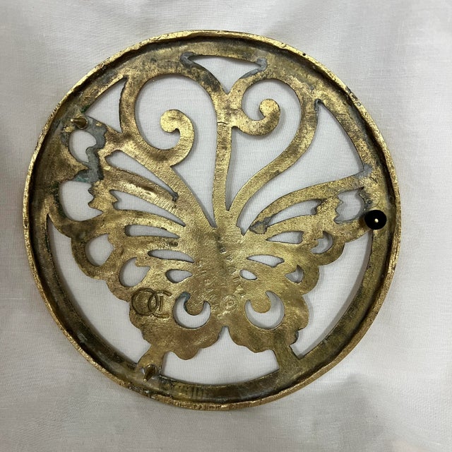 Mid century brass butterfly trivet. Measures 7” diameter.