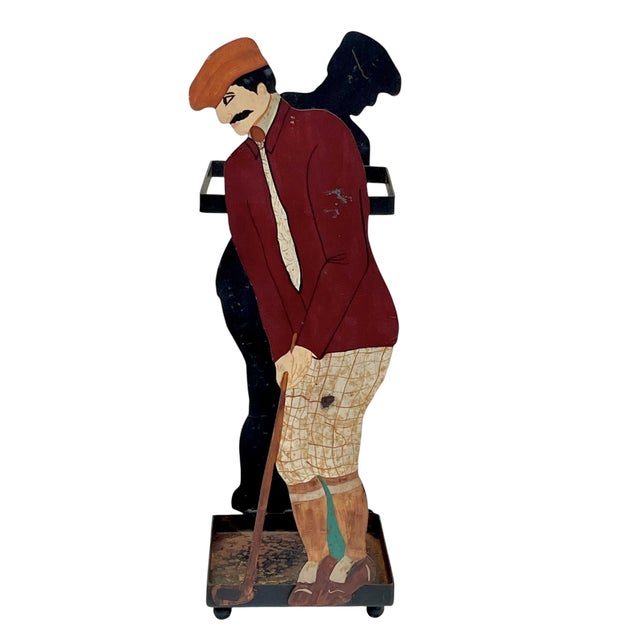 Charming vintage folk art umbrella stand featuring a whimsical hand-painted golfer or caddie figure in rich red, navy, and...