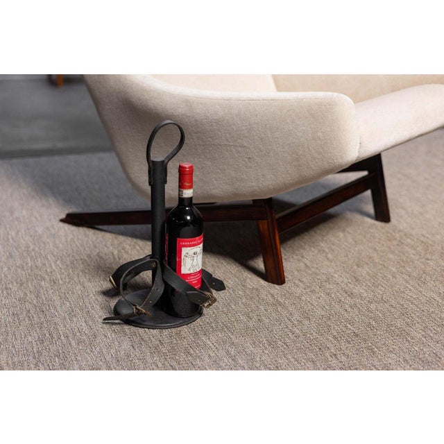 This rare and refined bottle holder by Jacques Adnet, signed “Modèle Déposé,” was made in France circa 1940 and...