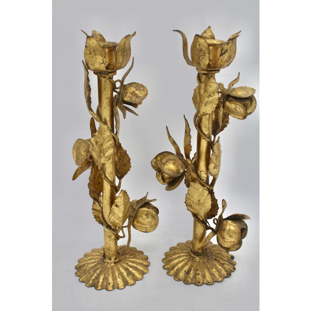 A stunning pair of gold gilded tole Italian candlesticks with flowers and a lovely scalloped base design, circa 1960s....