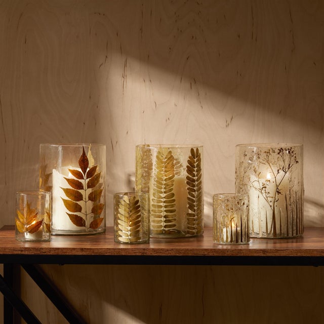 Bring the outdoors in with the Dried Leaf Glass Candle Holder. This glass vase features a beautiful dried rowan leaf...