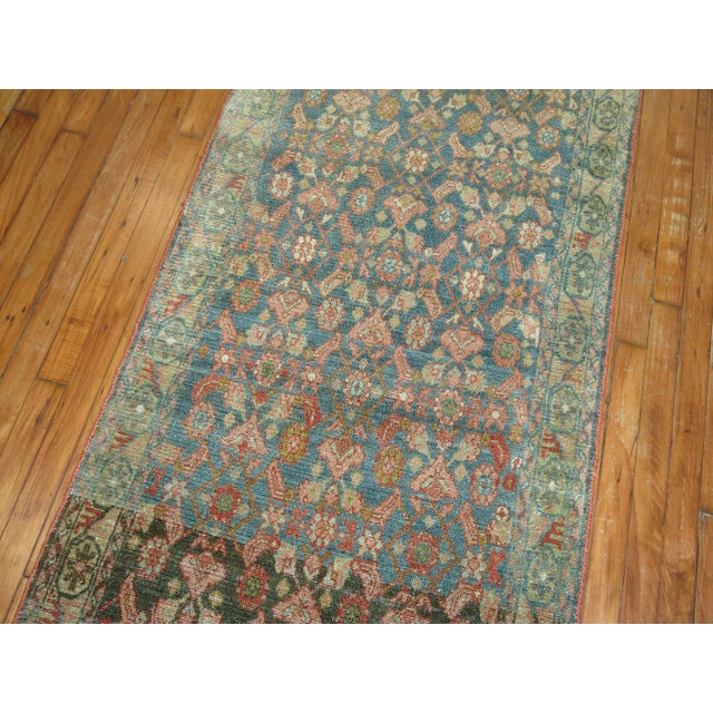 A long and narrow Persian Malayer runner from the early 20th century. Measures: 2'9" x 19'8".