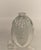 A T. Steinman art glass perfume bottle with a clear, bulbous body and a stopper. The bottle has a distinctive, swirled...