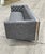 A Milo Baughman style, cantilevered sofa with tufted faux leather and chrome frame.