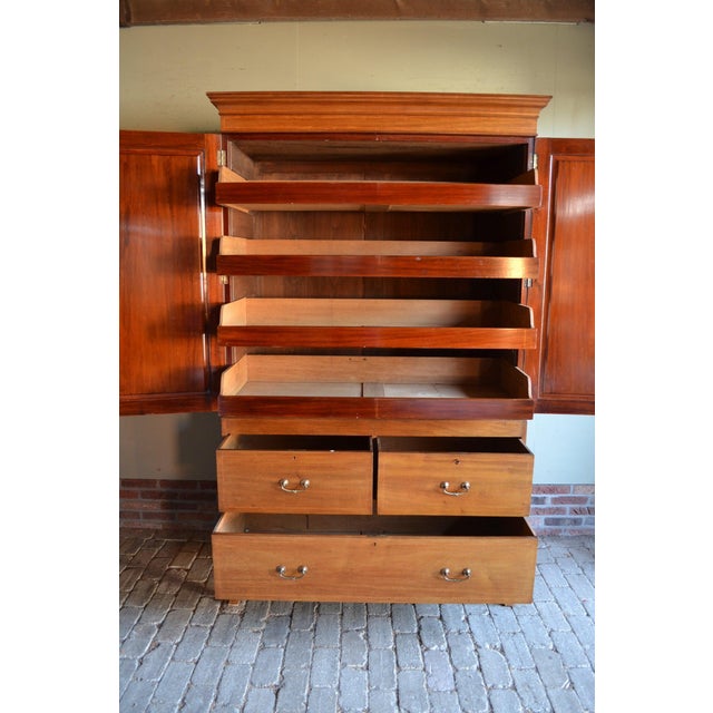A 19th-century English mahogany cabinet. The cabinet can be transported in two parts. The height is 210 cm. The width is...