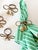 So charming! Set of six brass tassel bow napkin rings, "tied" out of a twisted brass rope. They are sturdy and fixed, not...