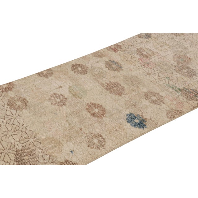This vintage runner rug is a 3x10 Turkish distressed piece, made with hand-knotted wool circa mid-20th century. It is an...
