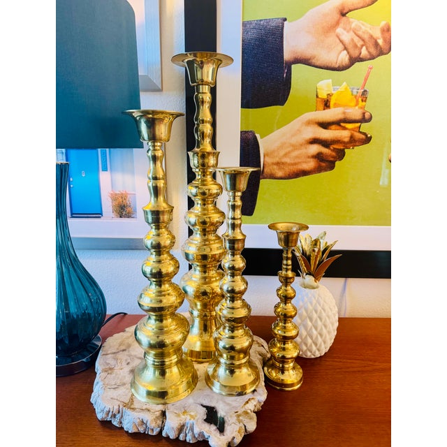 A striking set of four vintage oversized candlesticks, crafted in Japan and marked Venus Solid Brass. Each piece features...