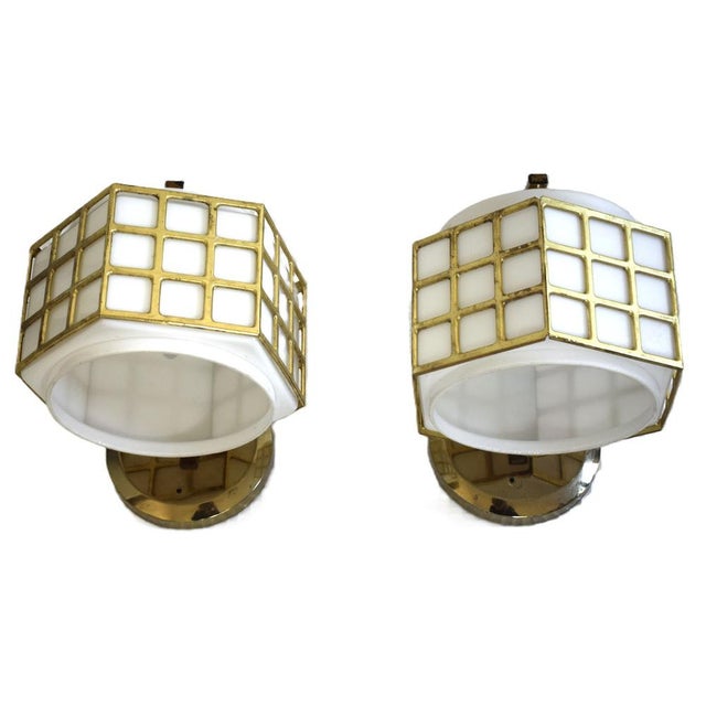 Two wall lamps in the constructive Viennese Art Nouveau style. Made in the 1960s. Brass and opal glass. Each with an E27...