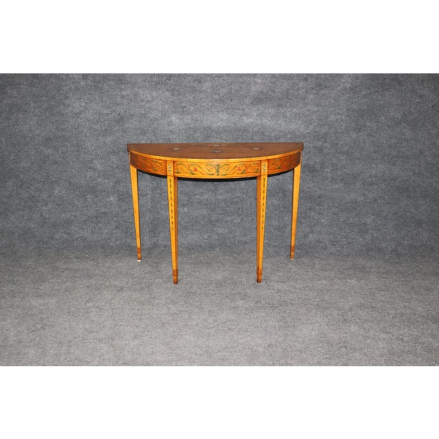 This exquisite Adams style demilune satinwood console table reflects the refined craftsmanship and classical beauty of...