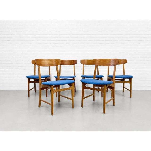 Set of six Mid Century Modern teak dining chairs crafted in Denmark by Farstrup Møbler, c. 1960's. Designed with timeless...