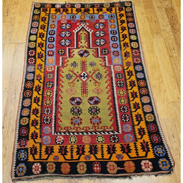 An exquisite early 20th-century vintage Turkish kilim featuring a rare and highly sought-after prayer rug (Mehrab) design,...