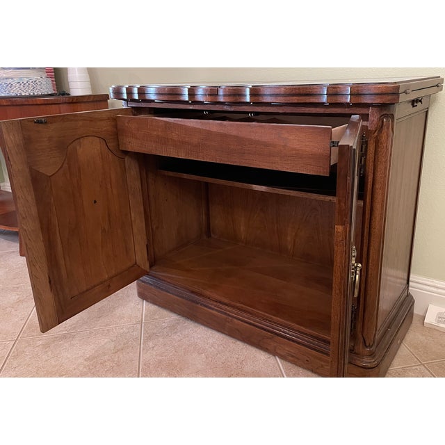Ornate wooden flip-top server has a dark heat-resistant laminate top surface when extended. This piece is constructed from...