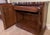 Ornate wooden flip-top server has a dark heat-resistant laminate top surface when extended. This piece is constructed from...