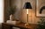 French-style bouillotte table lamp dating to the 1950s. A fluted and tapered brass candlestick column rises from an...