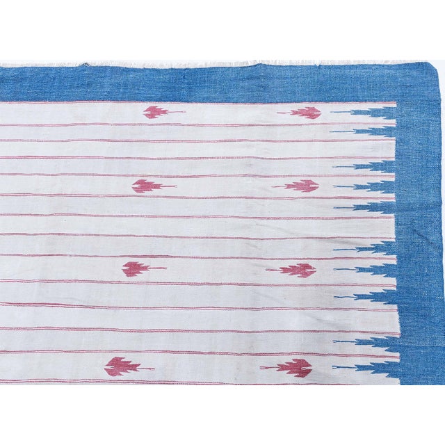 This vintage 1945 Indian Dhurrie rug embodies the understated elegance and graphic clarity characteristic of early 20th-...
