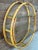Fabulous vintage circular rattan wall shelf featuring a sculptural double-ring frame in a warm honey-toned finish. The...