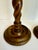This pair of early 20th century turned wood candlesticks features classic barley twist stems and substantial round bases....