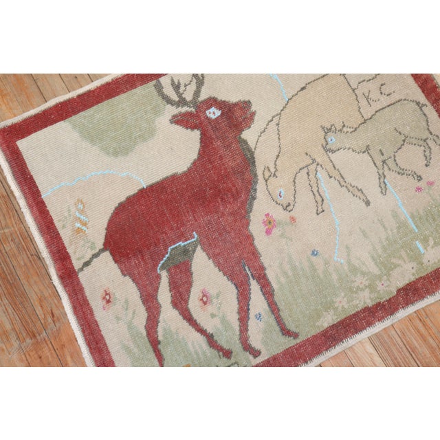 Mid-20th Century Turkish Rug depicting a Deer and 2 goats. Initialed KC, probably 1st letter of first and last name of the...