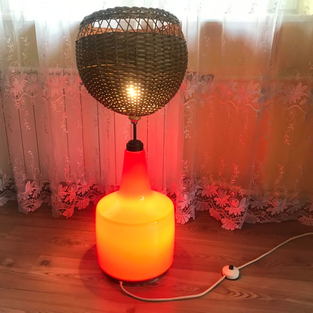 A large Indonesian table lamp made of double-layered glass, wicker and a brass base. It was made in the 70s It was...