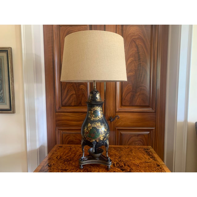 A charming black and gilt decorated Continental samovar of Northern European origin. The gilded and painted cartouche...