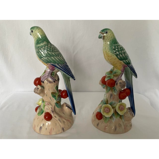 A beautiful pair of porcelain parrot statues in the majolica style. A classic addition to your table or set upon wall...