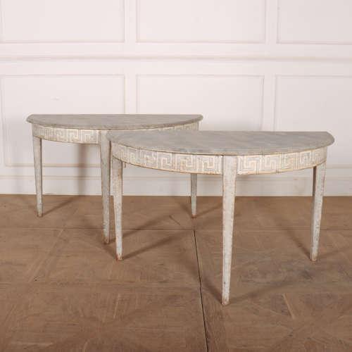 Wonderful pair of Swedish demi lune console tables with Greek key decoration to the friezes and a faux marble tops. 1820....