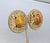1980s goldtone round cabochon faux-orange swirl agate rhinestone with flowers and leaves cut out surround clip earrings....