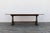 A beautiful 1940s French farmhouse dining table handcrafted from solid oak, featuring a timeless trestle base and a richly...