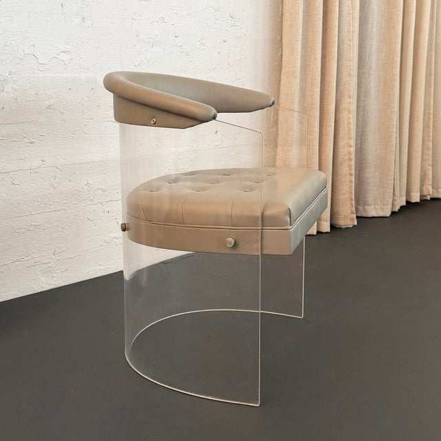 This is a classic 1970s Lucite floating barrel tub chair designed in the manner of Vladimir Kagan. It features a curved...
