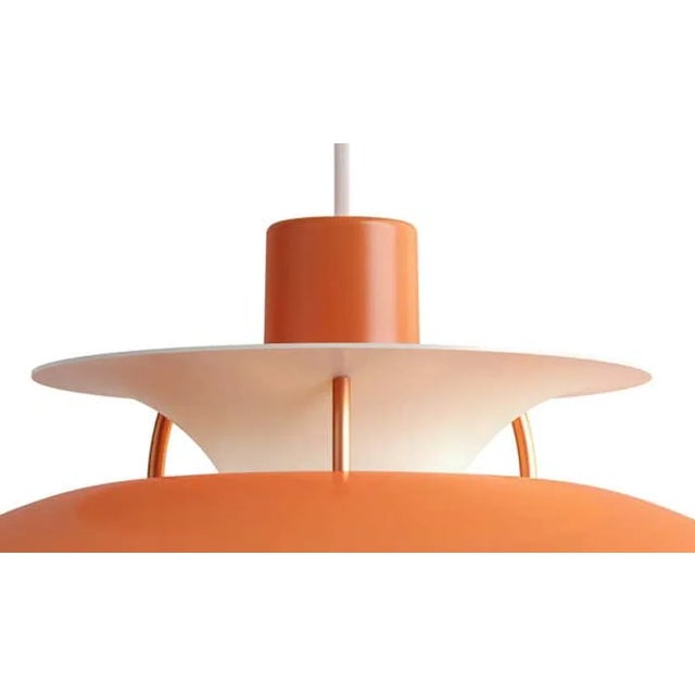 Poul Henningson orange PH5 mini pendants for Louis Poulsen. Poul Henningsen originally introduced the full-sized PH 5...