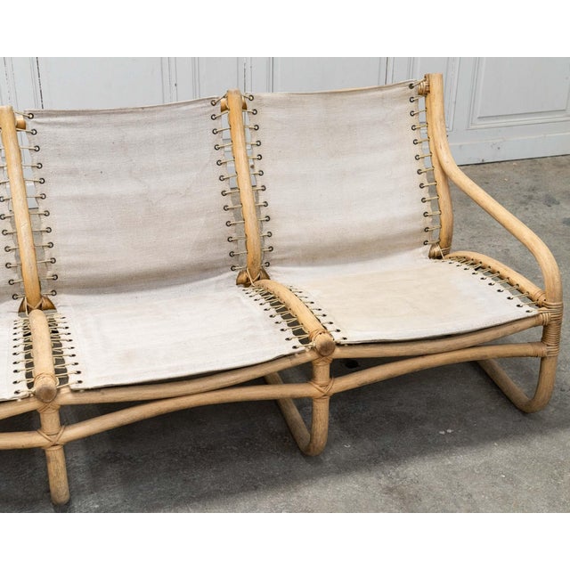 with its flowing lines and rattan frame, this vintage 3-seater bench captivates with its understated yet unique design....