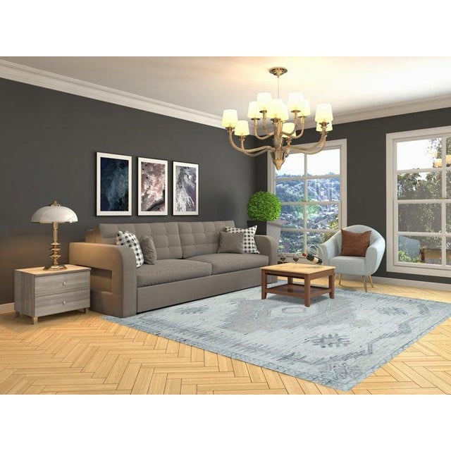 This hand knotted wool rug features a classic Oushak style design suitable for various home interiors. Crafted in India,...