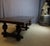 A very large oak table with six baluster legs in the Renaissance style. The top is parquet-patterned and the legs are...