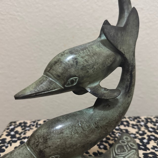 Bring a touch of ocean-inspired elegance to your space with this beautifully crafted bronze sculpture featuring two...